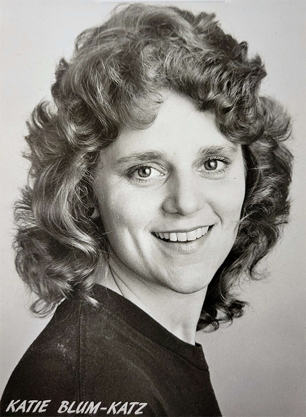 Black-and-white portrait photo of Katie with curly hair.
