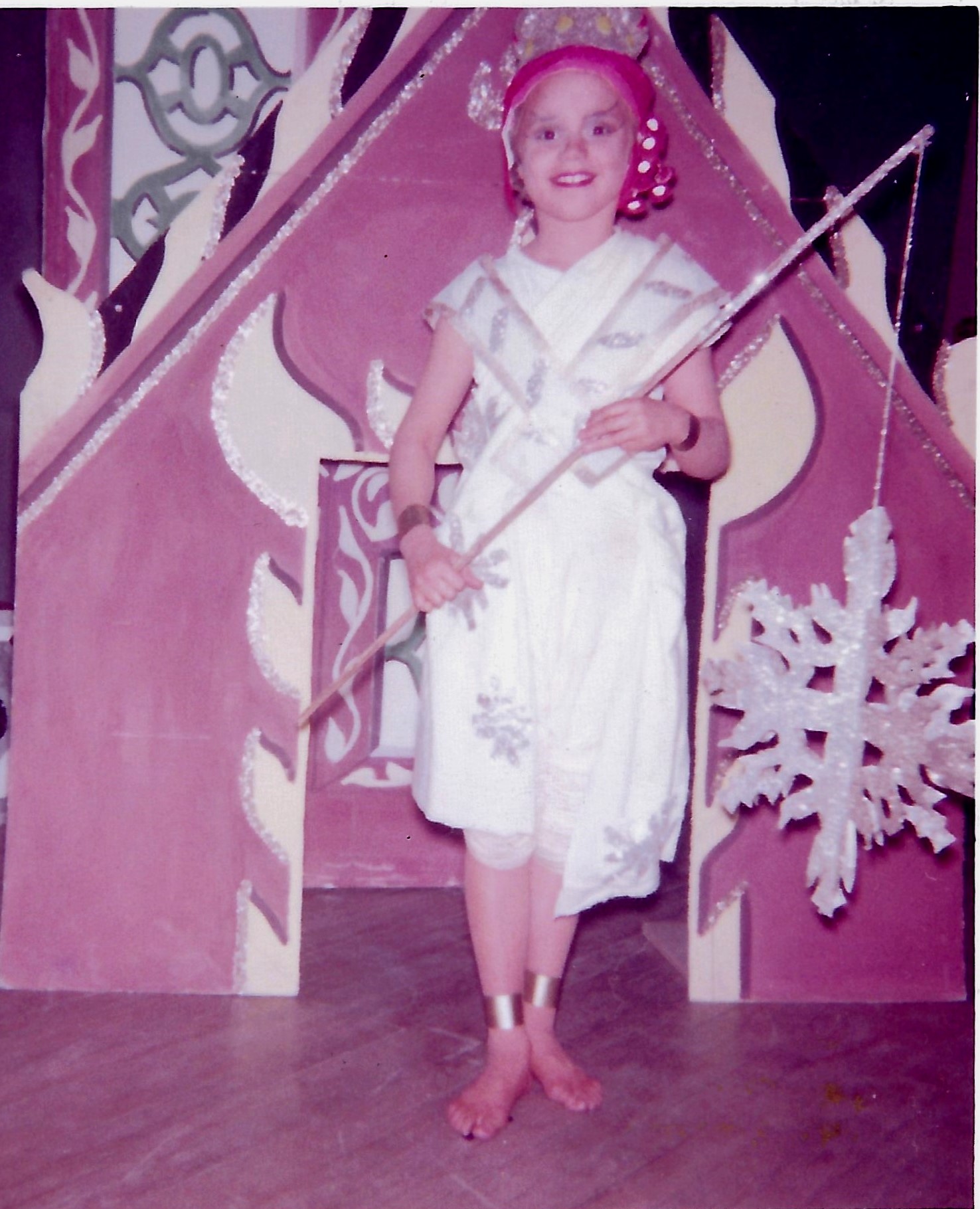 Childhood photo of Katie in a pink costume at Uncle Tom's Cabin, holding a wand.